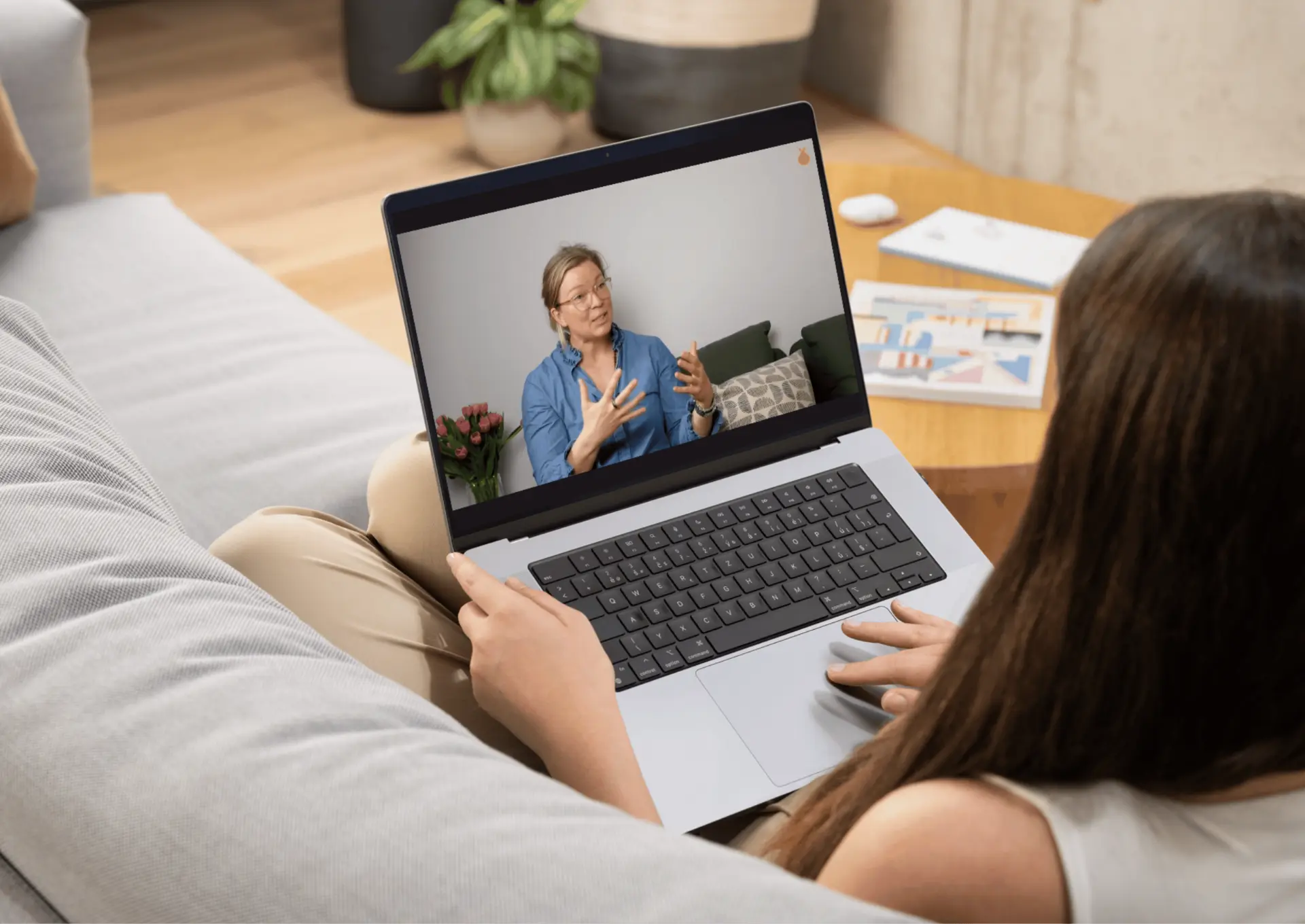 A Storka participant watching a bite-sized lesson on her laptop
